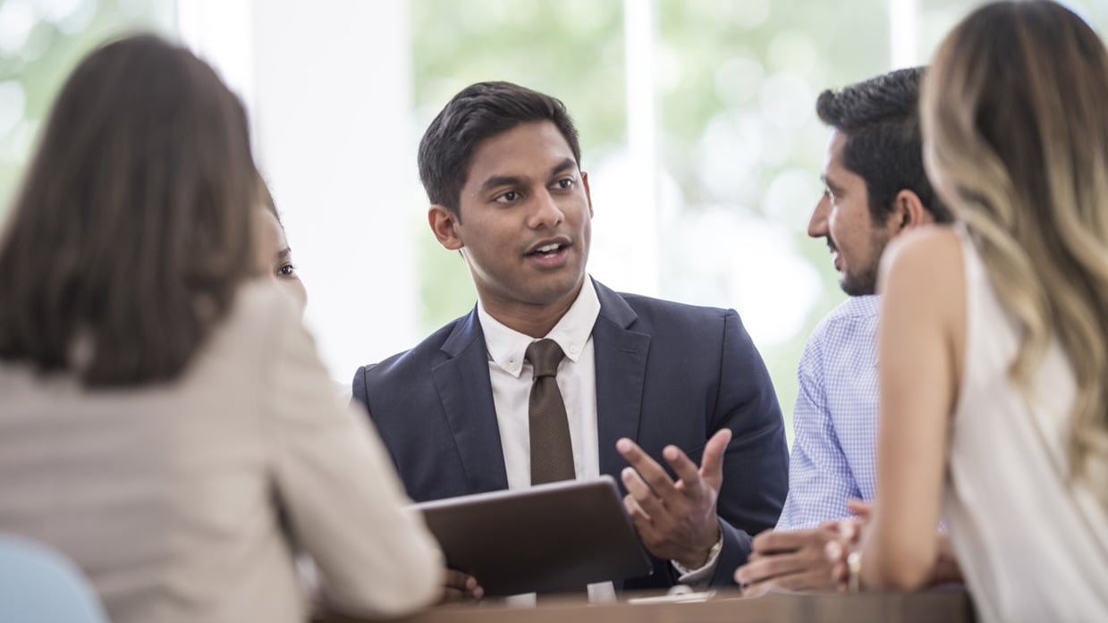 man talking to group people